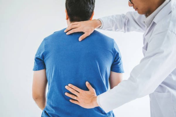 Physical Doctor consulting with patient about Back problems Physical therapy concept